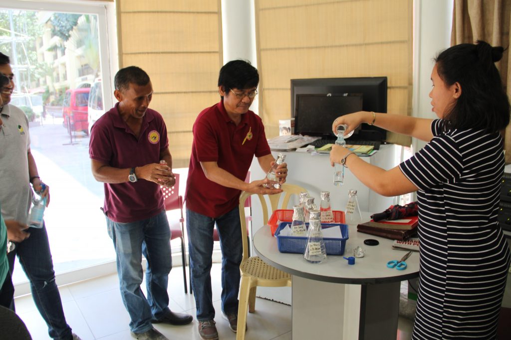 Ms. Mechelle Canoy, PIO Staff is distributing rations of the 70% ethyl alcohol with mosquito repellent made by Dr. Milagros Greif to the different personnel in the University.